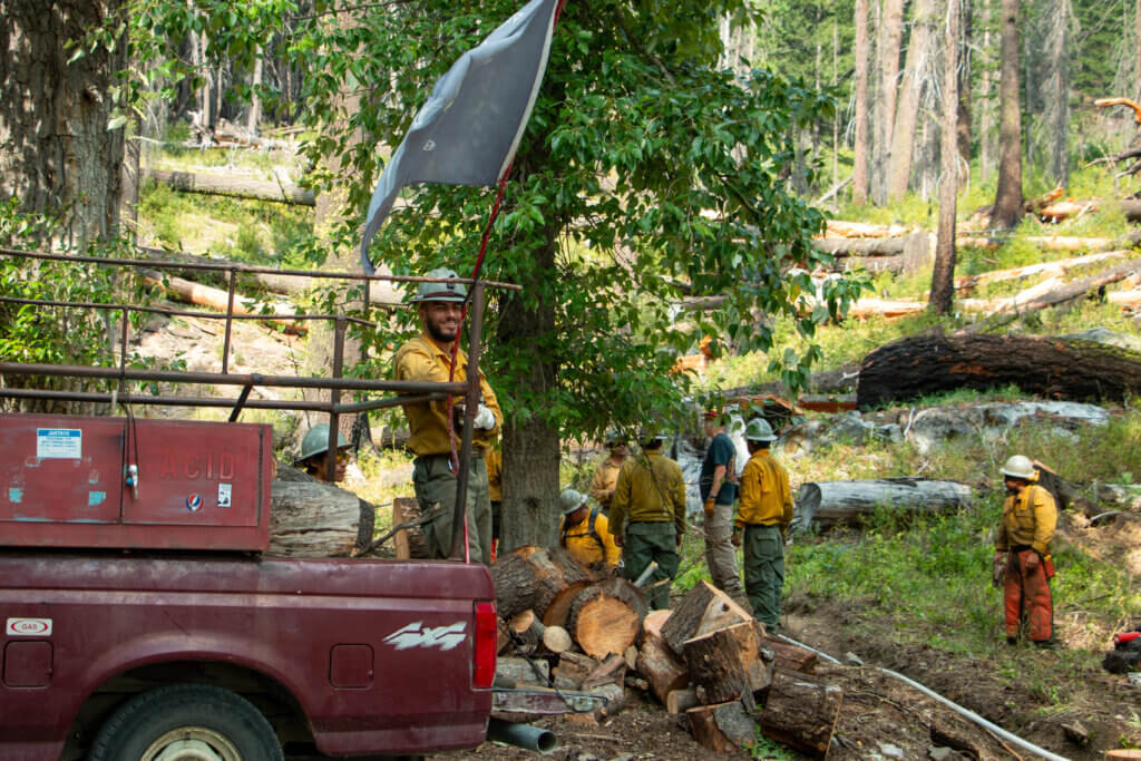 Firefighter clear debris from around the Village