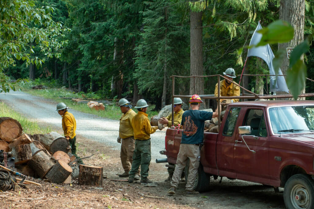 Firefighter clear debris from around the Village